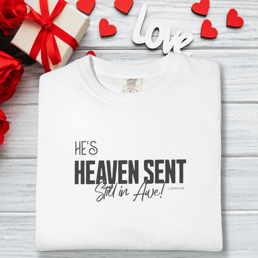 Women’s He’s Heaven Sent Still in Awe 1 John 4:19 Tee